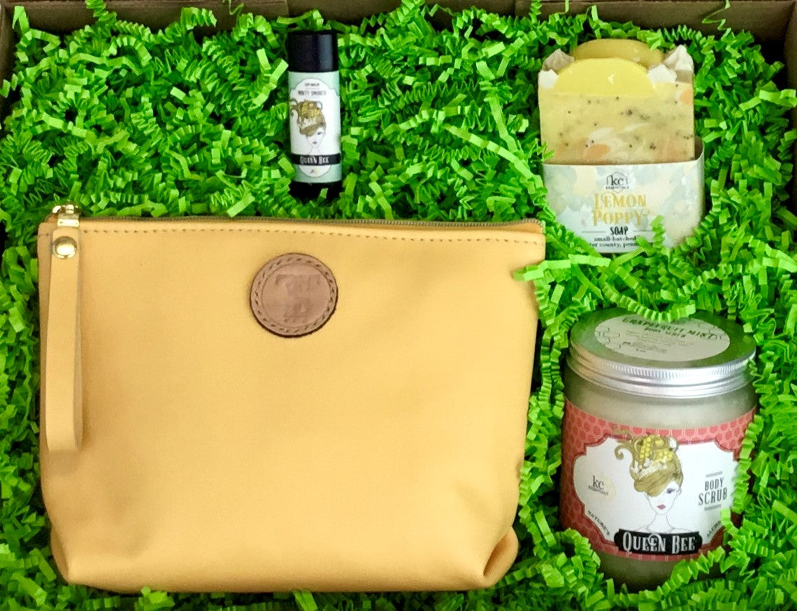 Town & Shore Handcrafted Serenity Gift set featuring T5 Leather bath kit and brush bag shown in saffron yellow calfskin leather. KC Essentials artisan made vegan bar soap, essential oils body scrub and soothing lip balm. Arranged in gift box with sustainable eco-friendly bright green crinkle paper.