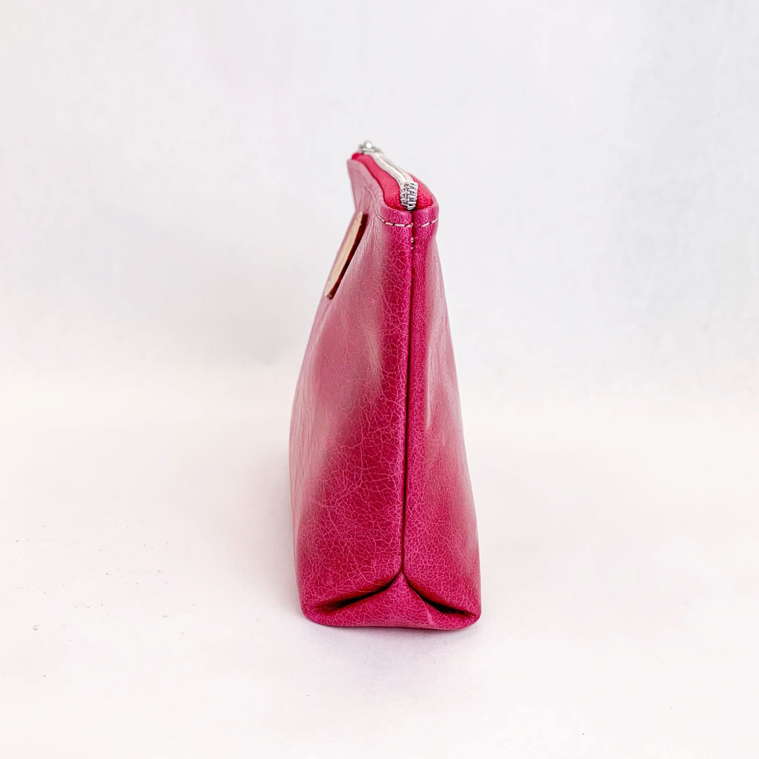 Side view T5 Cosmetics case toiletry bag designer handcrafted in smooth calf leather in hot Barbie pink.