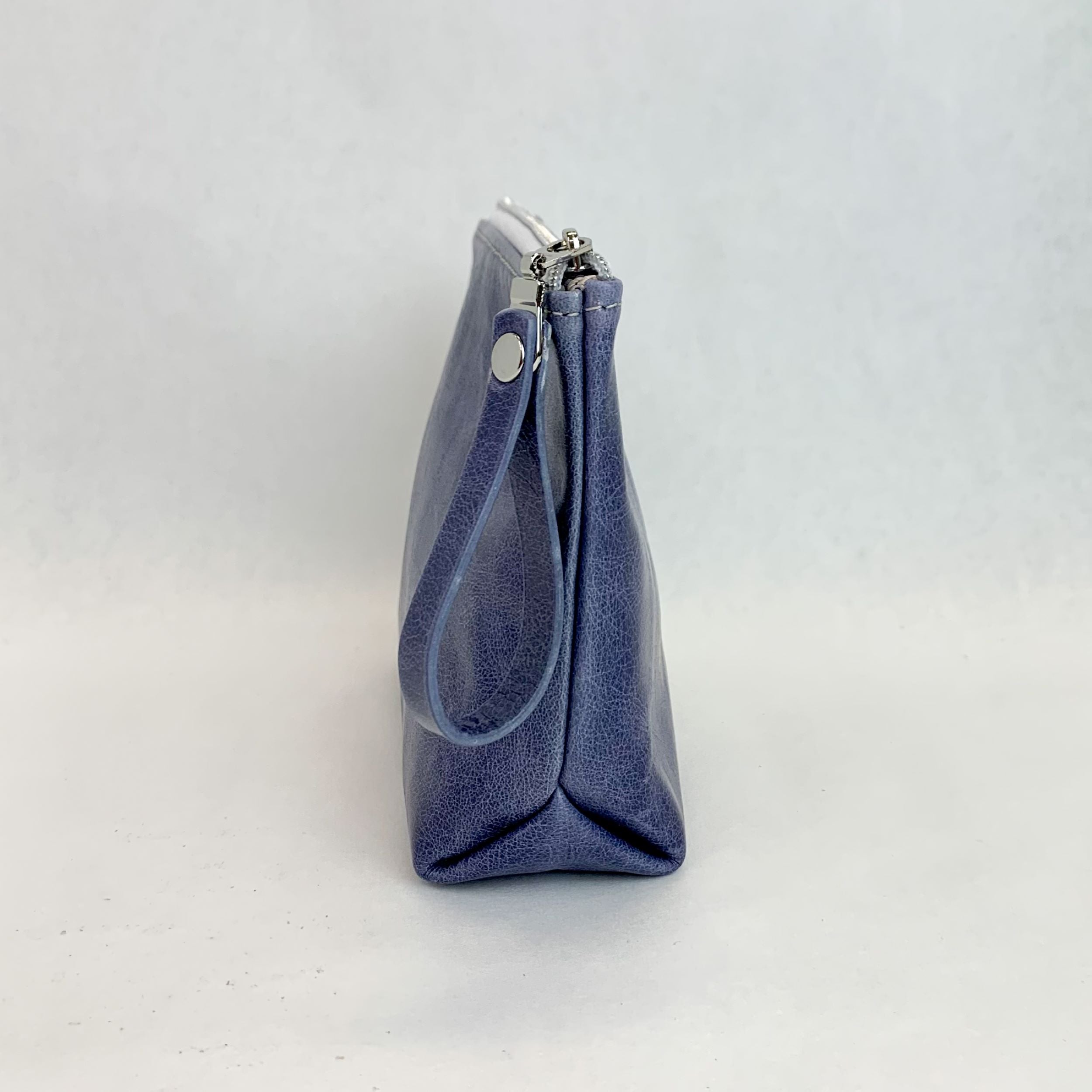 Side view T5 Cosmetics case toiletry bag designer handcrafted in smooth calf leather in denim blue.