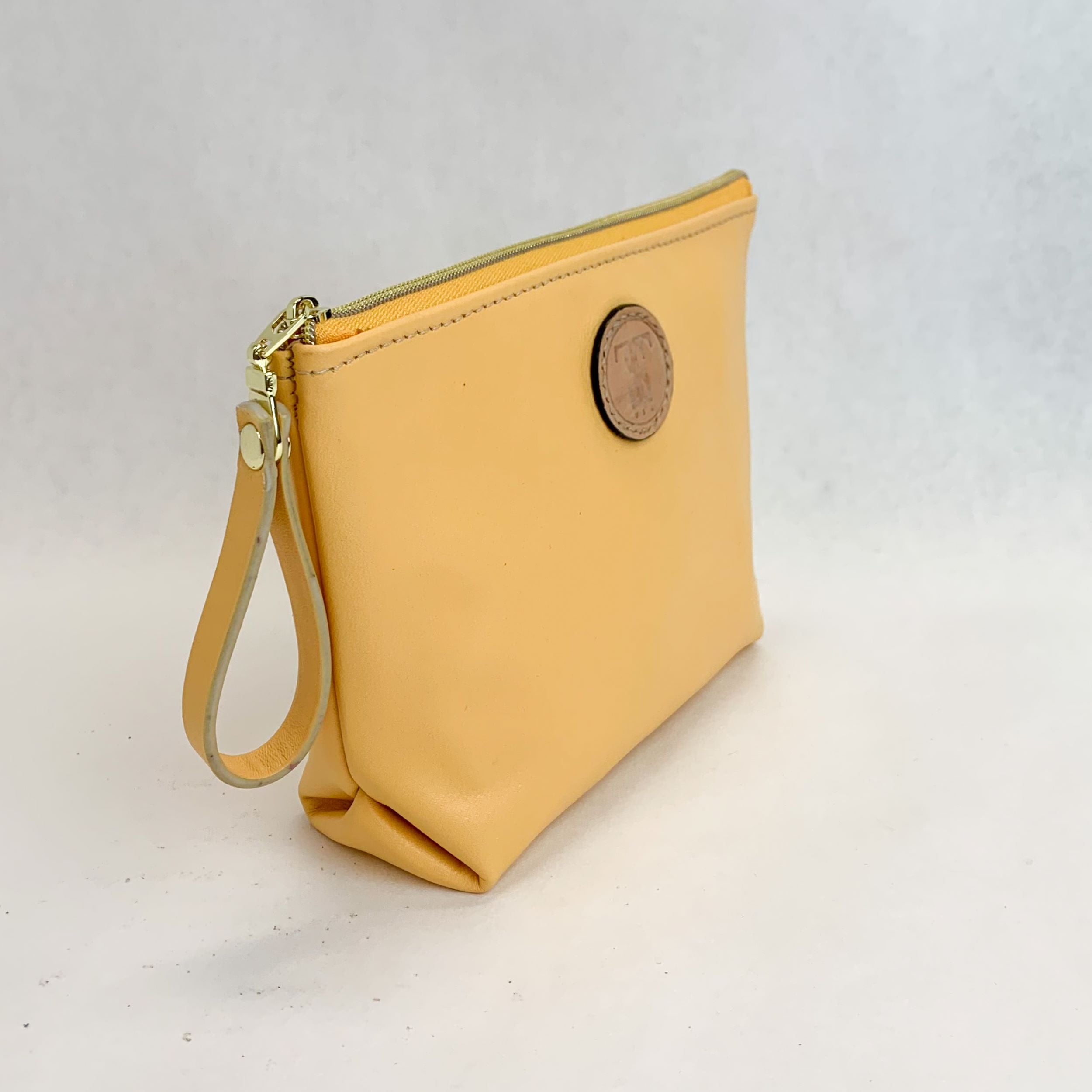 Side view T5 Cosmetics case toiletry bag designer handcrafted in smooth calf leather in saffron yellow.