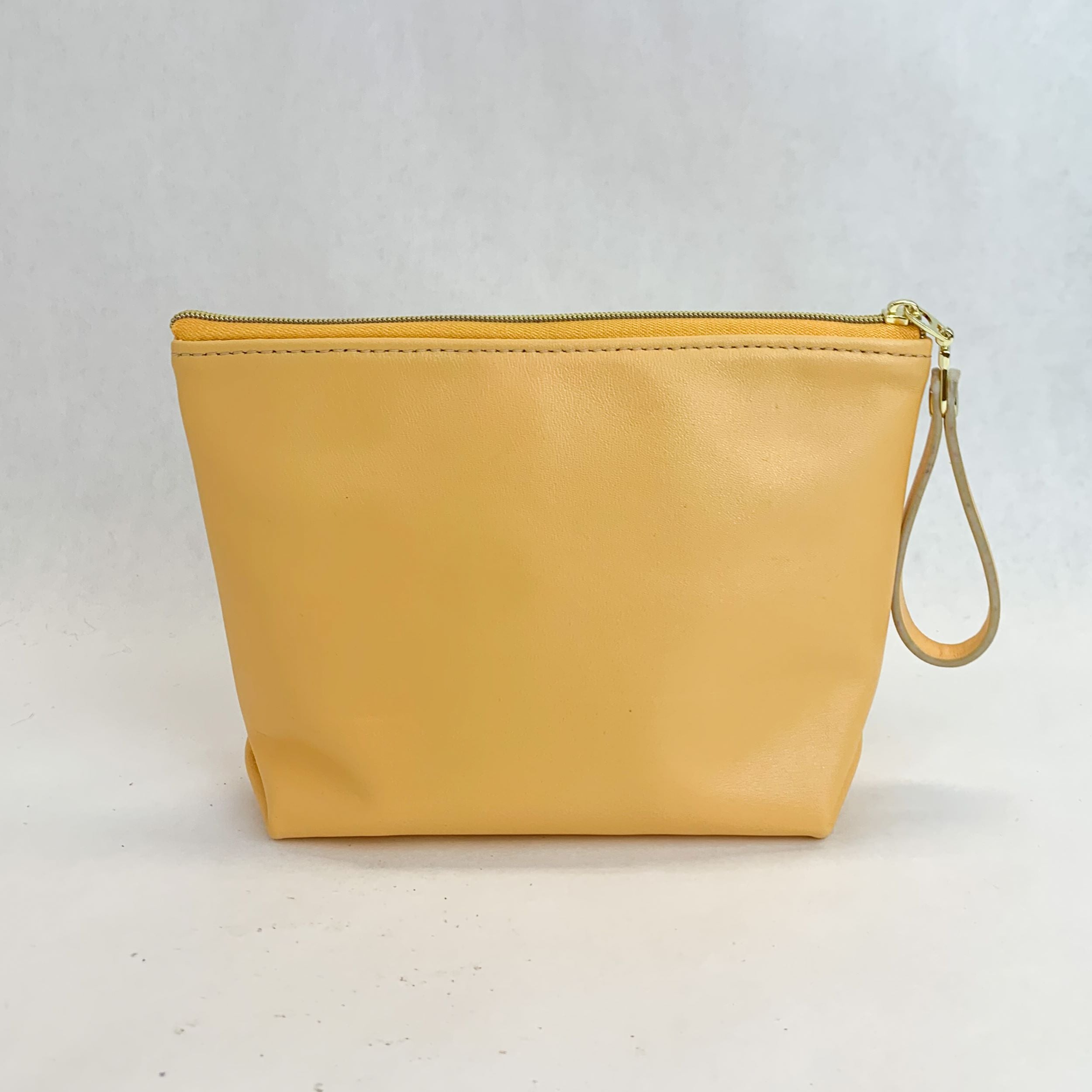 Back view T5 Cosmetics case toiletry bag designer handcrafted in smooth calf leather in saffron yellow.