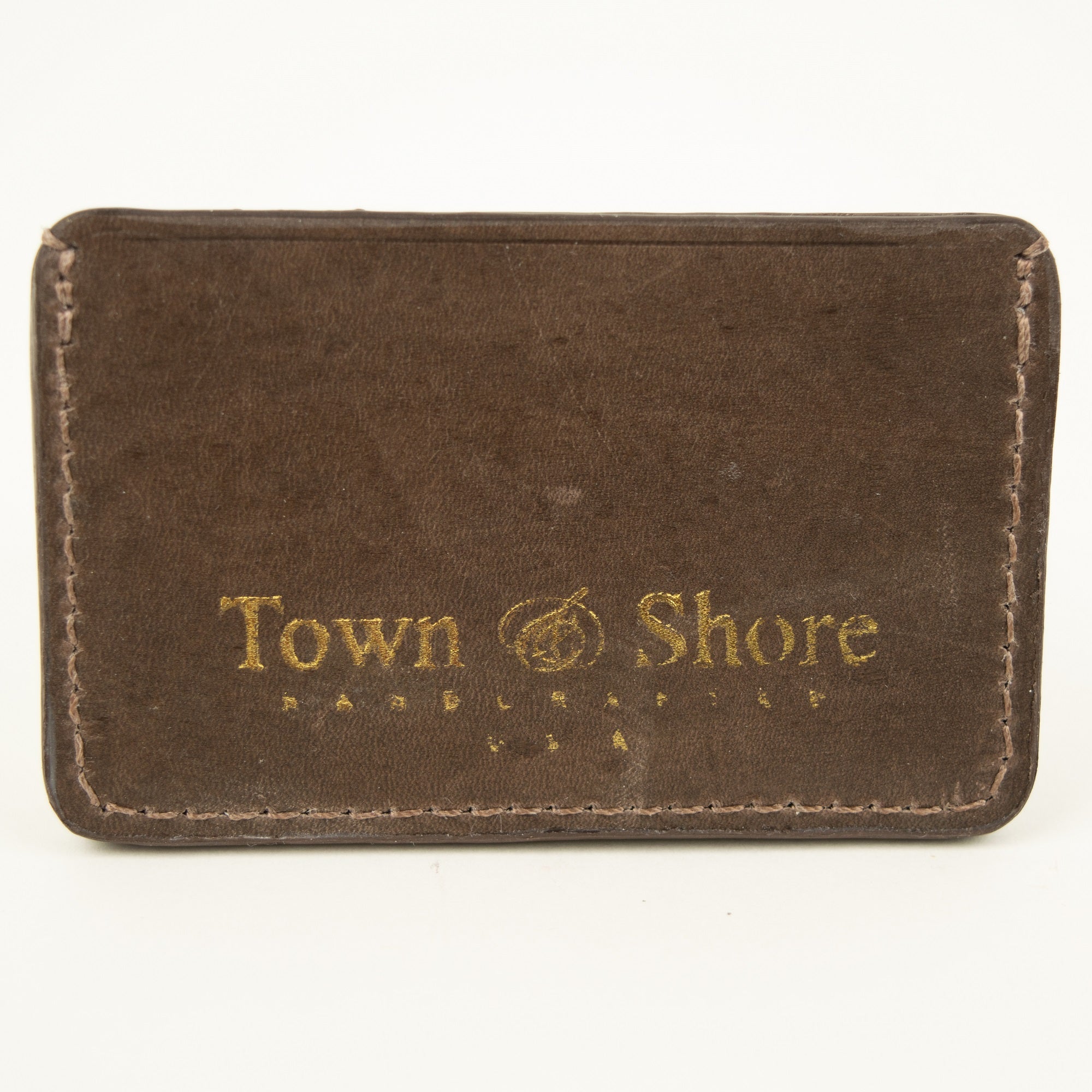 Back view of Distressed finish Chocolate brown leather slim card case with two front pockets center pocket gold brand logos on back