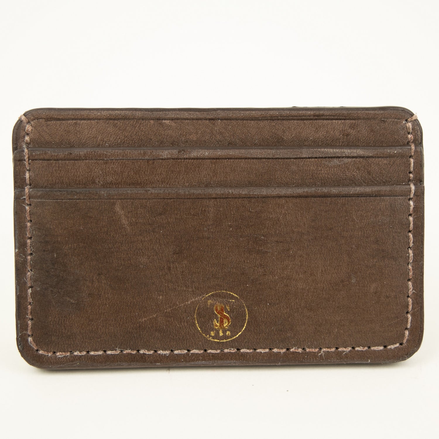 Front view of Distressed finish Chocolate brown leather slim card case with two front pockets center pocket gold brand logos on front 