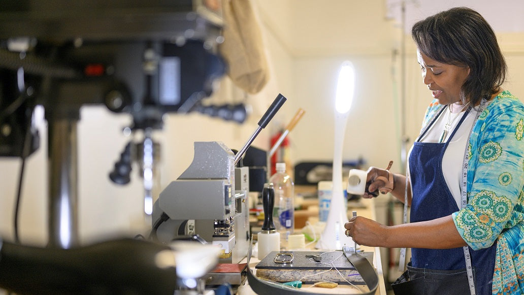 Designer Liv McClintock hammering a belt in her leather studio. Photo Credits: Moonloop Photograpy_Scott Ciancio