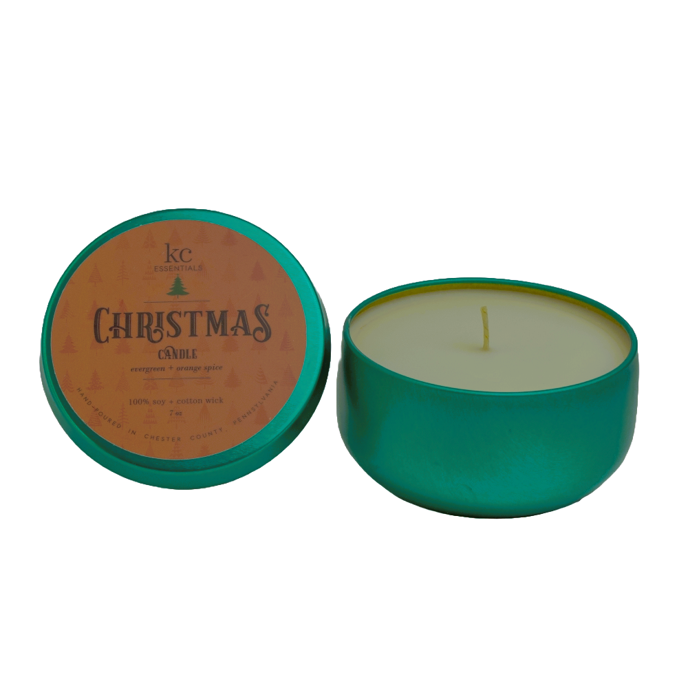 Lid and open Christmas soy wax candle is made of natural ingredients in bright green colored metal tin. 