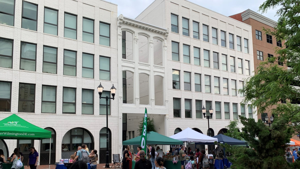 People attending festival on the 200 block of Market street Wilmington Delaware in front of the Cooper apartment building. Photograph by Town & Shore Apparel Inc.