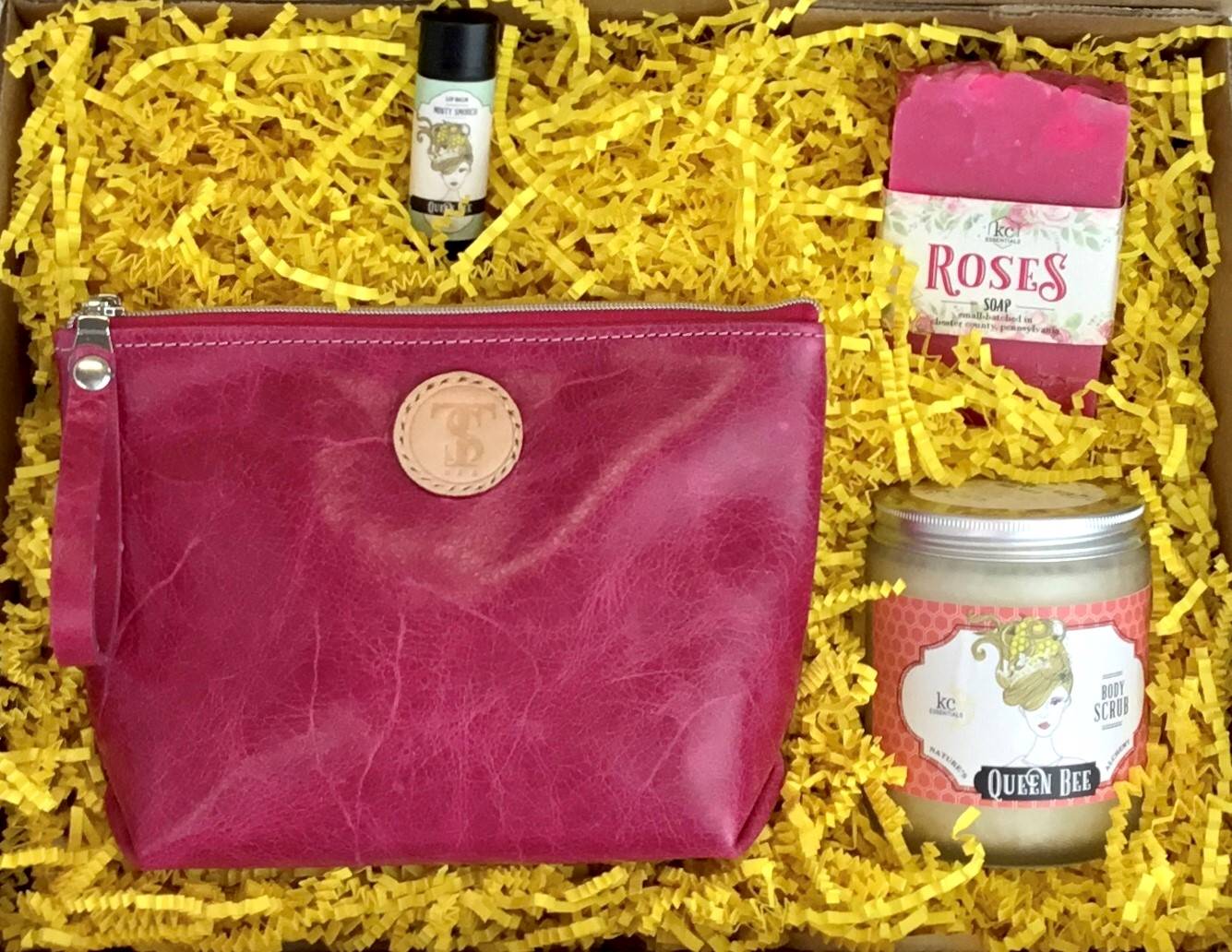 Town &amp; Shore Handcrafted Serenity Gift set featuring T5 Leather bath kit and brush bag shown in hot pink calfskin leather. KC Essentials artisan made vegan bar soap, essential oils body scrub and soothing lip balm. Arranged in gift box with sustainable eco-friendly yellow crinkle paper.