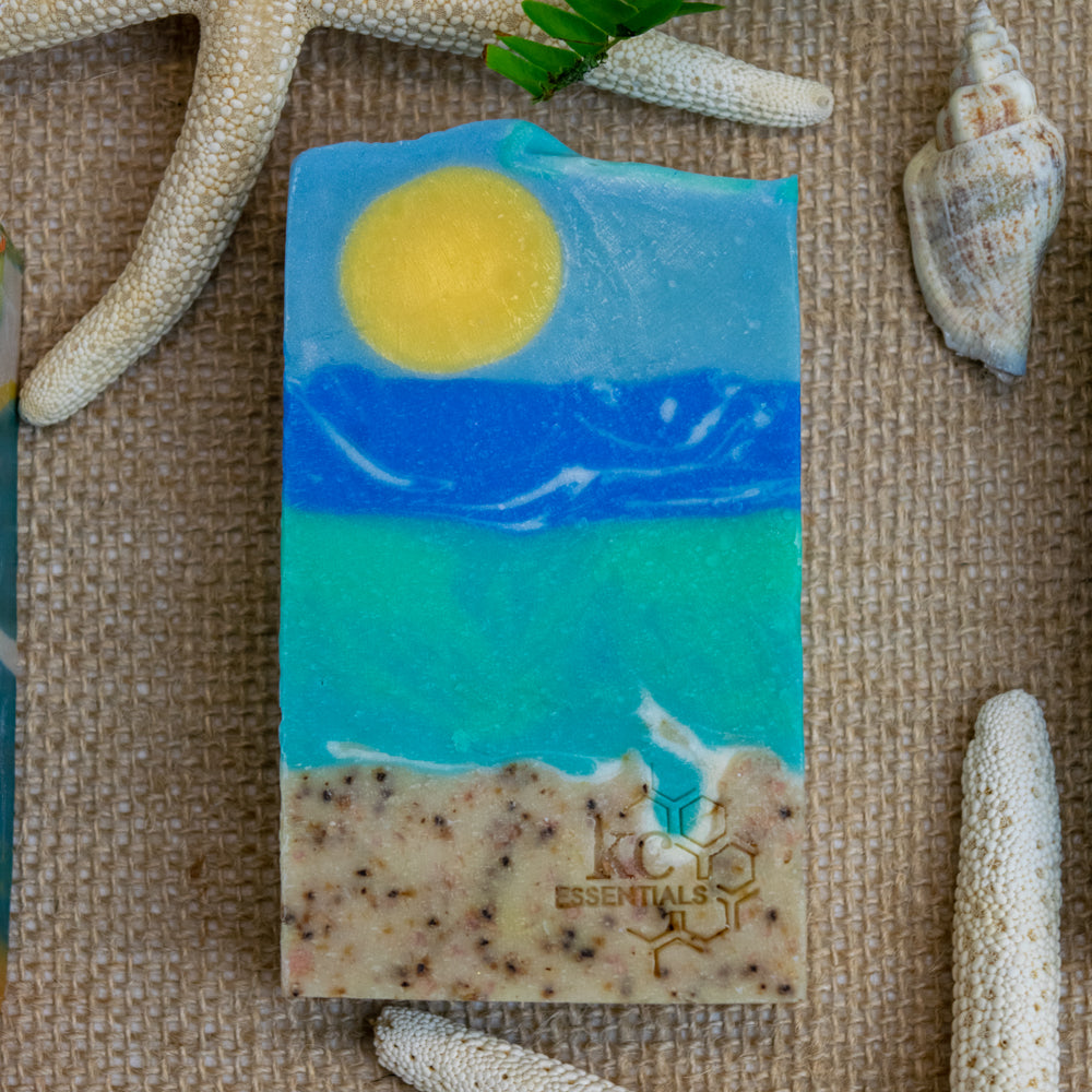 Artisan Bar Soap that shows a beach with sand surf and yellow sun high in the blue sky with wisps of clouds