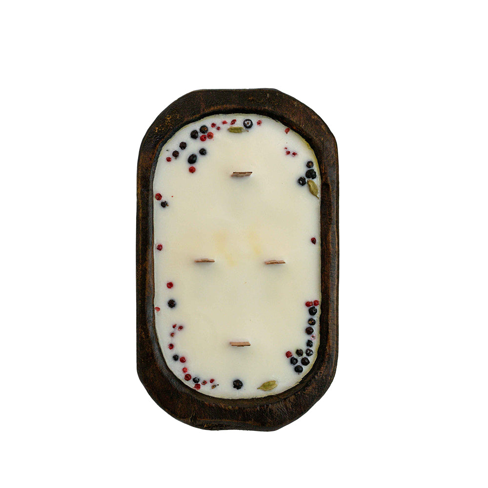 Top view of Large table table size Holiday Village soy wax candle from KC Essentials in hand carved walnut brown wood dough bowl . Great for display for Christmas or holiday decorating and gifts.