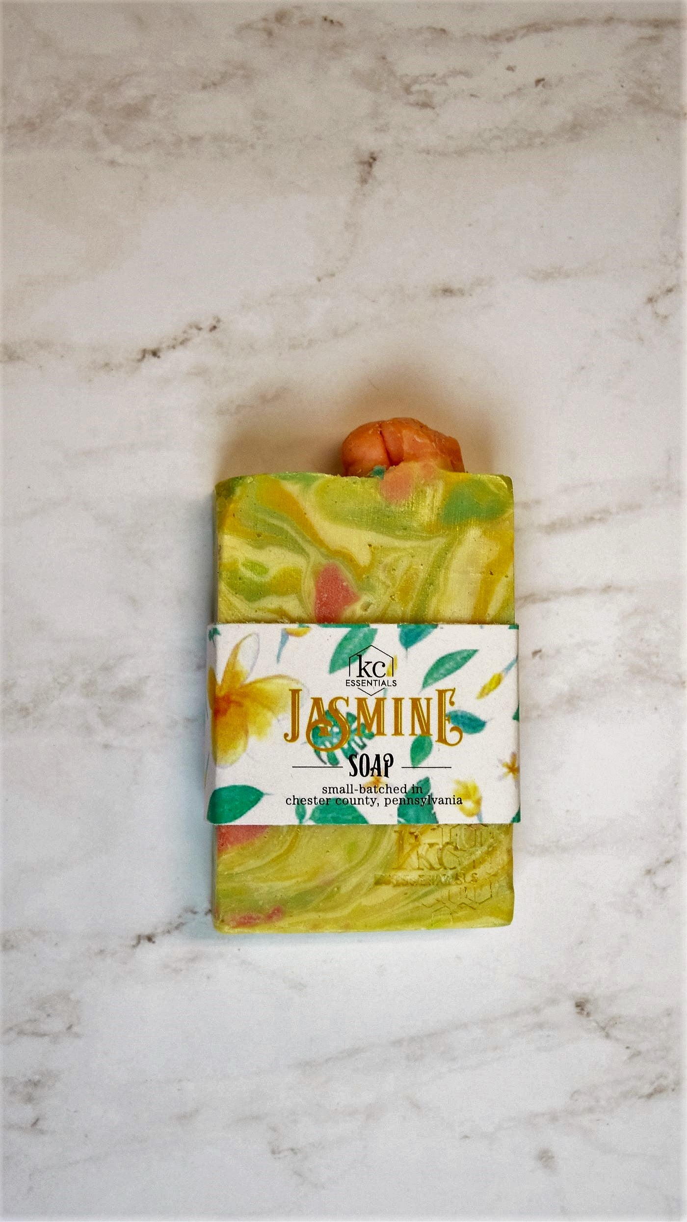 Swirls of yellow, green and orange in the marbled artisan soap bar.