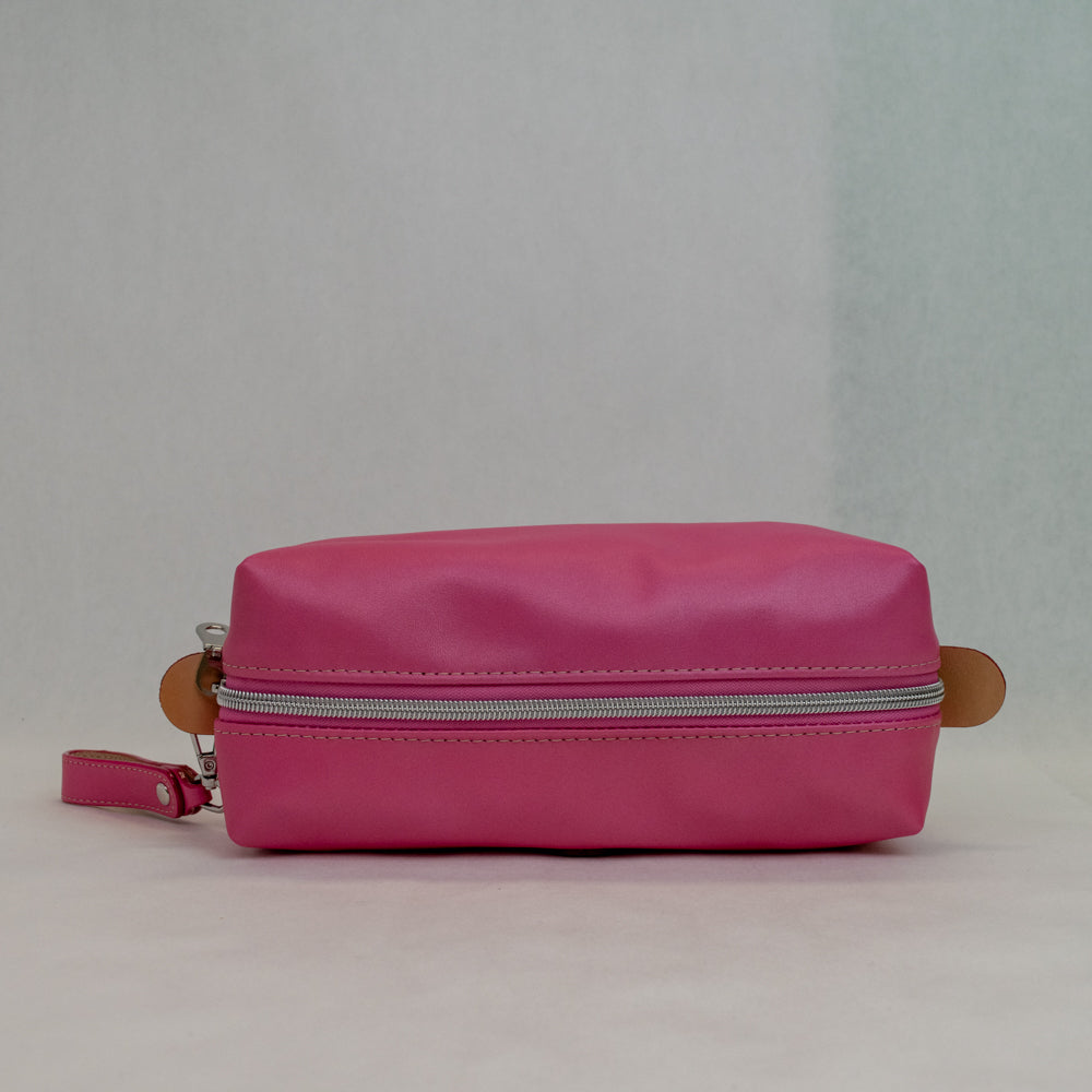 Top view of T5 bath dopp kit toiletry wash bag designer handcrafted of smooth calf leather in frosted pink.