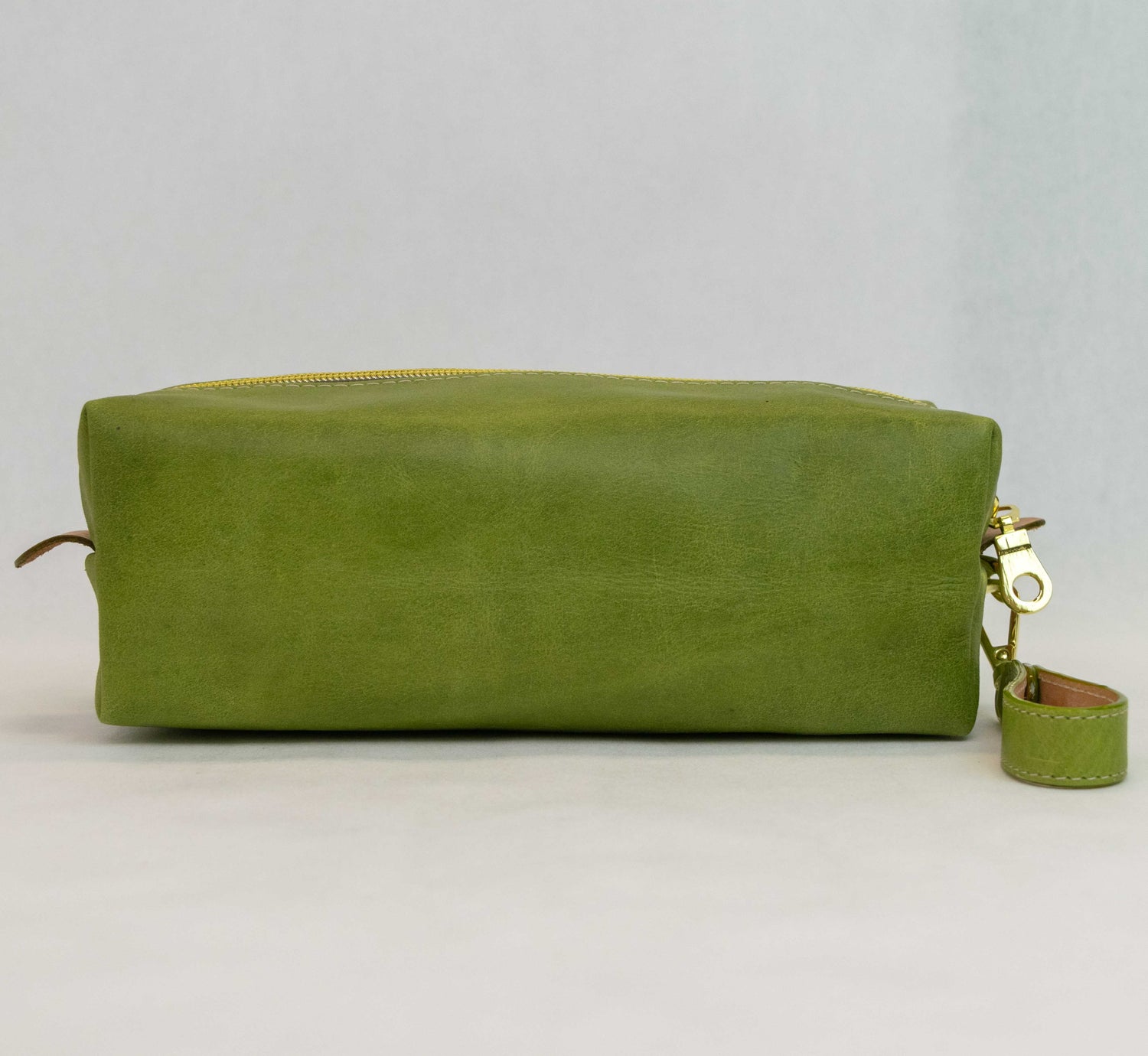 Back view of T5 bath dopp kit toiletry wash bag designer handcrafted of smooth calf leather in vintage aloe green.