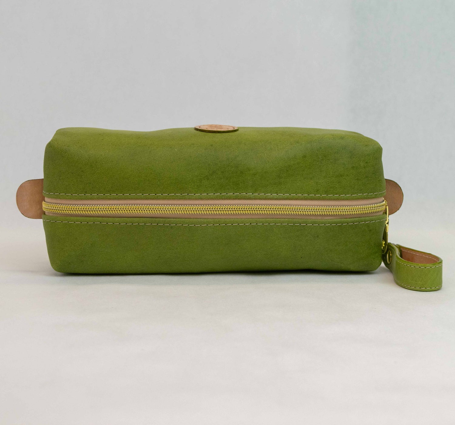 Top view of T5 bath dopp kit toiletry wash bag designer handcrafted of smooth calf leather in vintage aloe green.