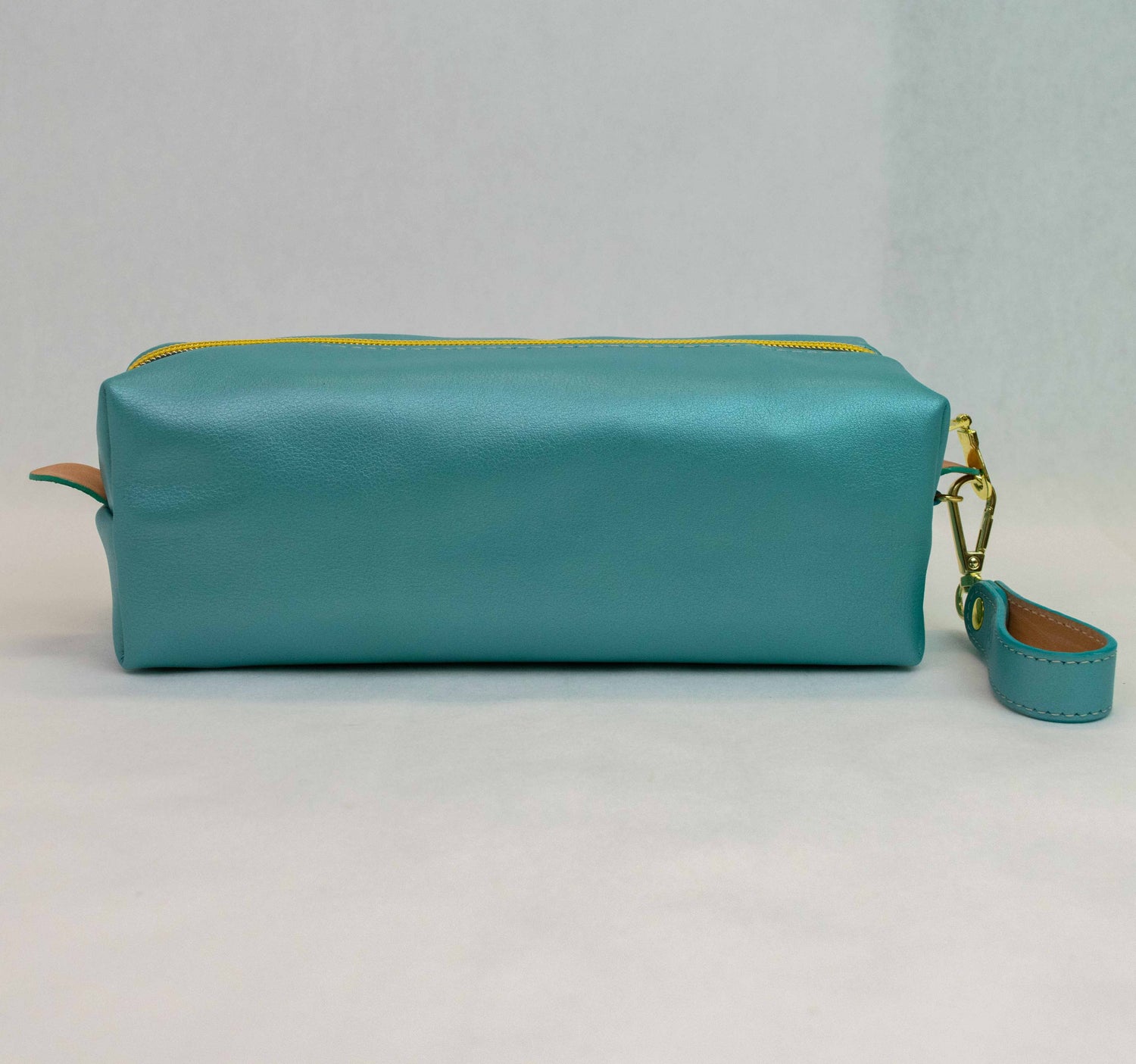 Back view of T5 bath dopp kit toiletry wash bag designer handcrafted of smooth calf leather in frosted turquoise..