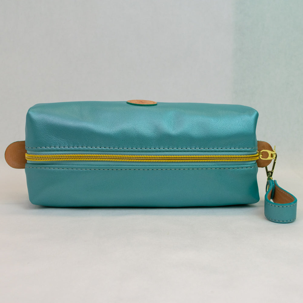 Top view of T5 bath dopp kit toiletry wash bag designer handcrafted of smooth calf leather in frosted turquoise..