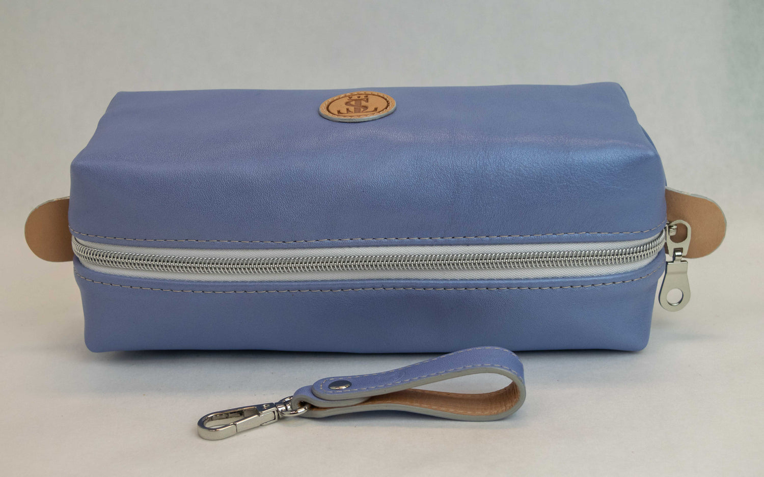 Top view of T5 bath dopp kit toiletry wash bag designer handcrafted of smooth calf leather in light Periwinkle blue.