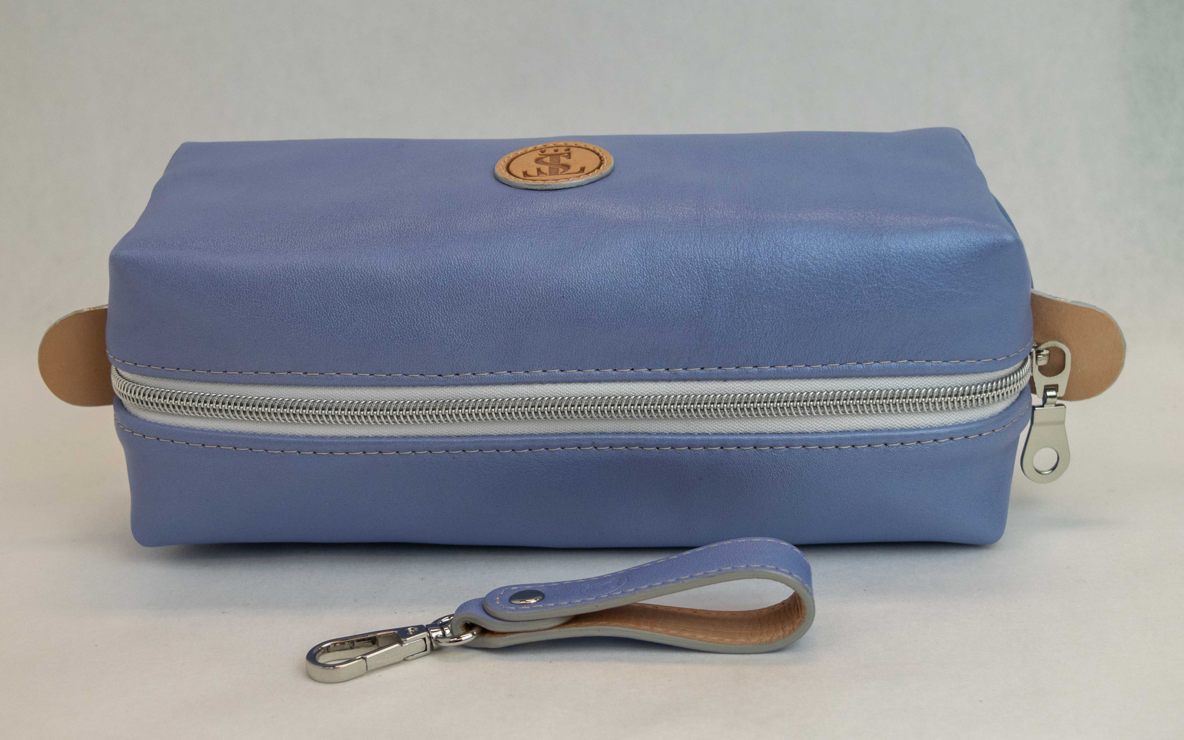 Top view of T5 bath dopp kit toiletry wash bag designer handcrafted of smooth calf leather in light Periwinkle blue.
