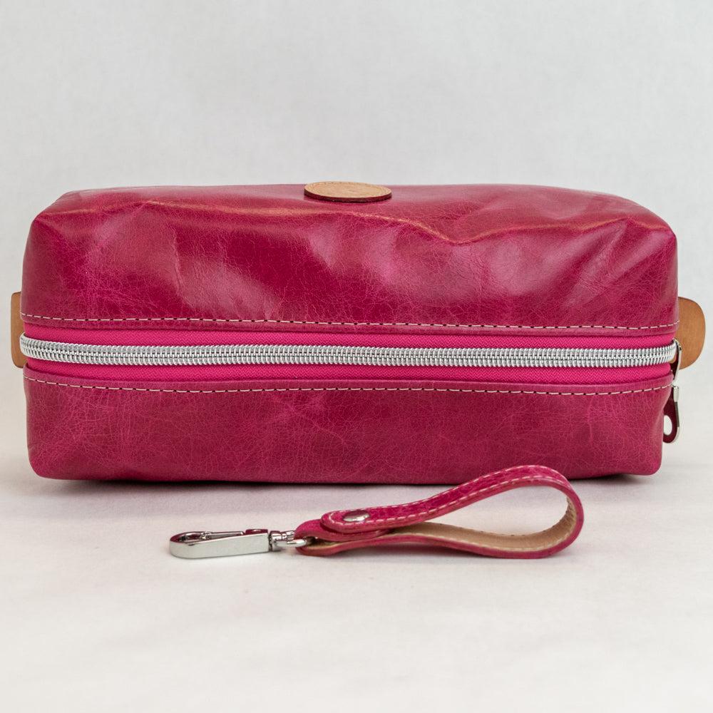 Top view of T5 bath dopp kit toiletry wash bag designer handcrafted of smooth calf leather in hot Barbie pink.