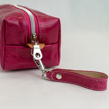 Side view of T5 bath dopp kit toiletry wash bag designer handcrafted of smooth calf leather in hot Barbie pink.