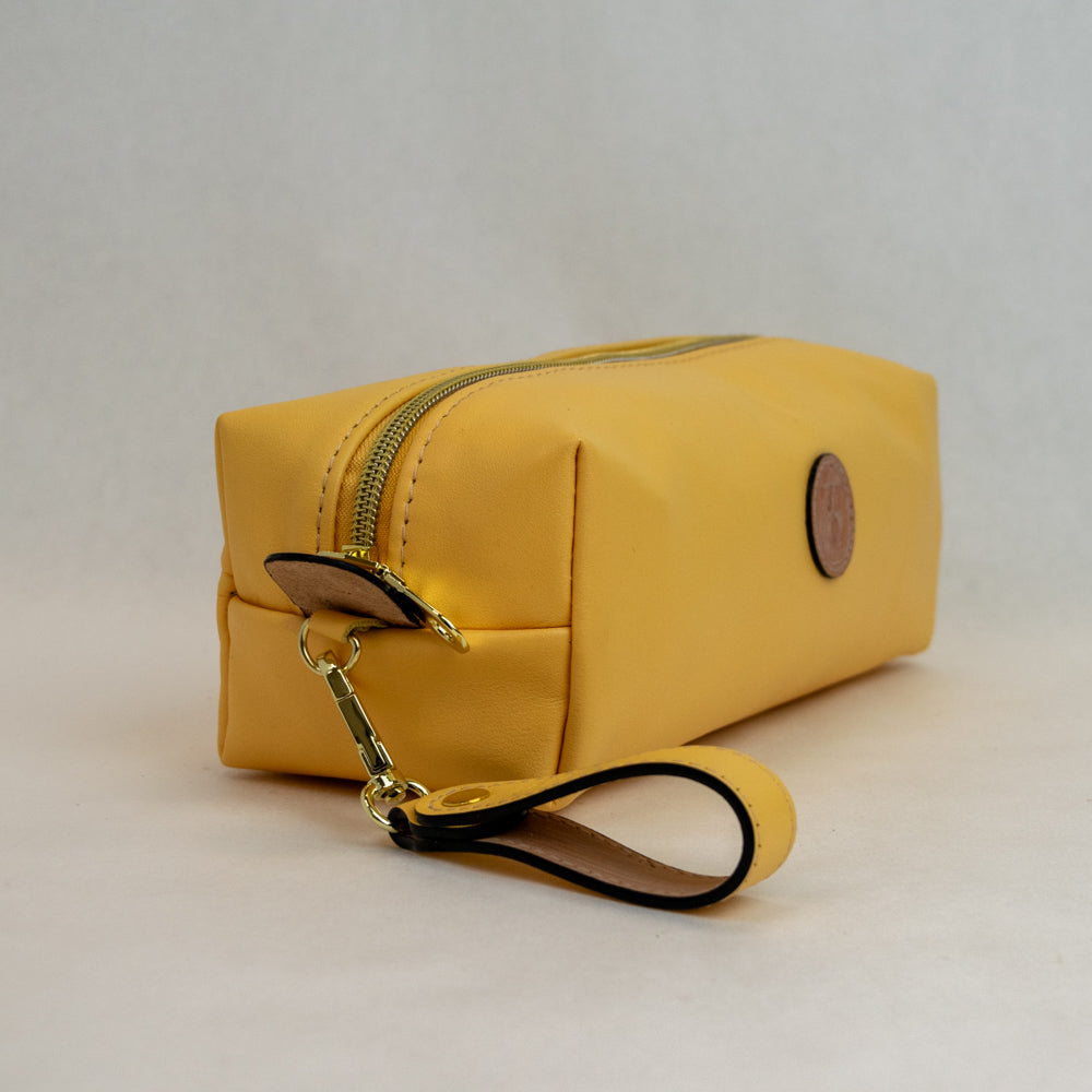 Side view of T5 bath dopp kit toiletry wash bag designer handcrafted of smooth calf leather in saffron yellow.