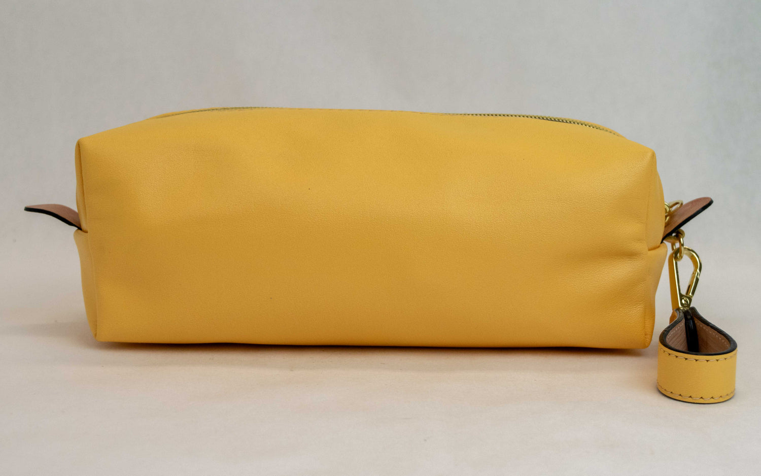 Back view of T5 bath dopp kit toiletry wash bag designer handcrafted of smooth calf leather in saffron yellow.