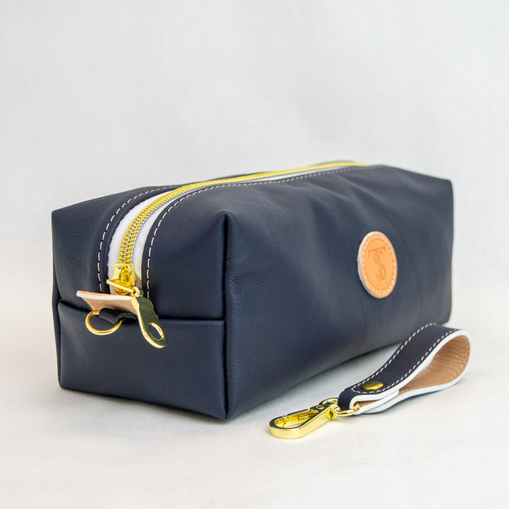 Side view of T5 bath dopp kit toiletry wash bag designer handcrafted of smooth calf leather in nautical navy blue.