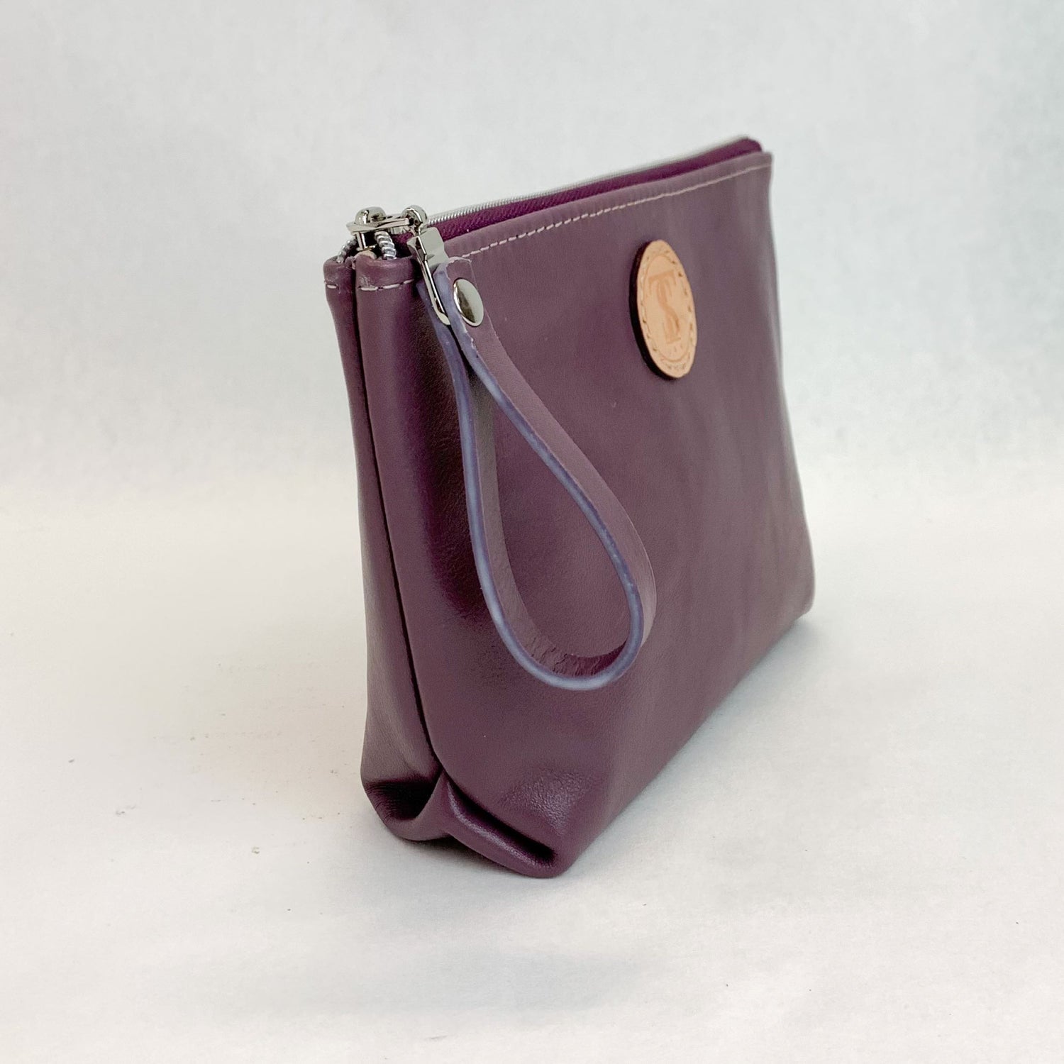 Side view T5 Cosmetics case toiletry bag designer handcrafted in smooth calf leather in lavender purple.