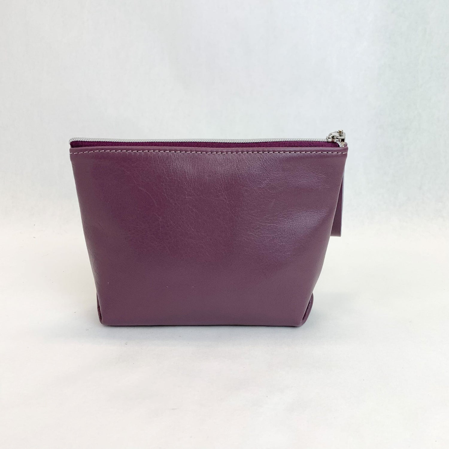Back view T5 Cosmetics case toiletry bag designer handcrafted in smooth calf leather in lavender purple.