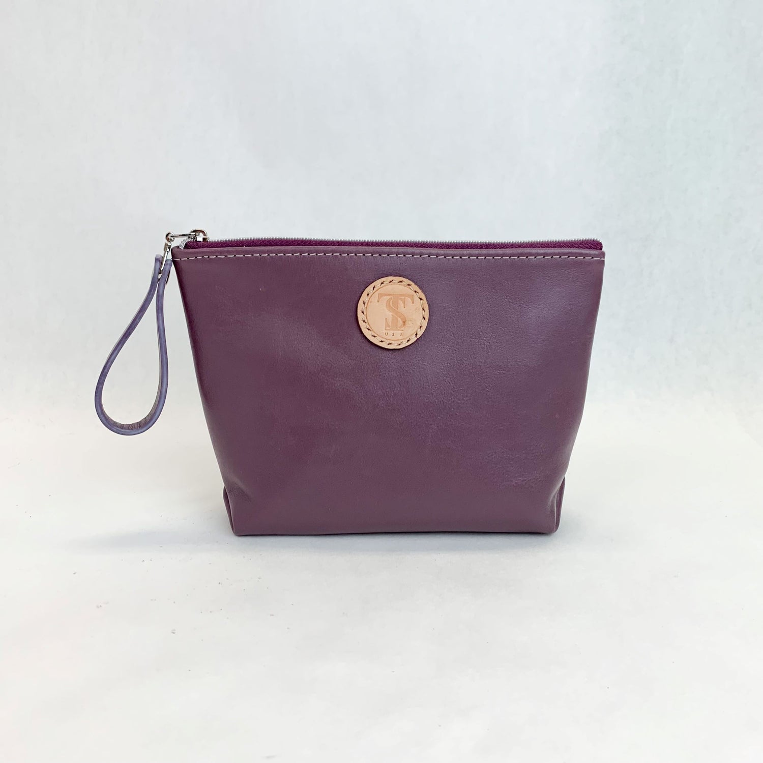 Front view T5 Cosmetics case toiletry bag designer handcrafted in smooth calf leather in lavender purple.