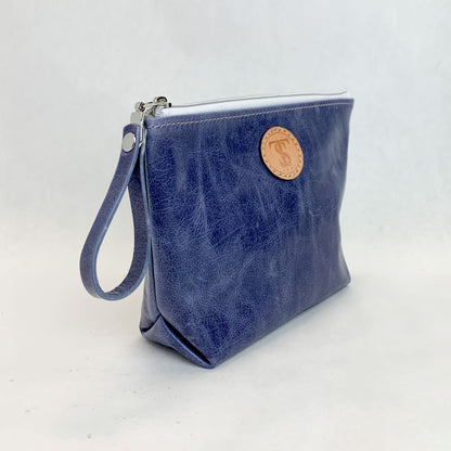 Side view T5 Cosmetics case toiletry bag designer handcrafted in smooth calf leather in denim blue.