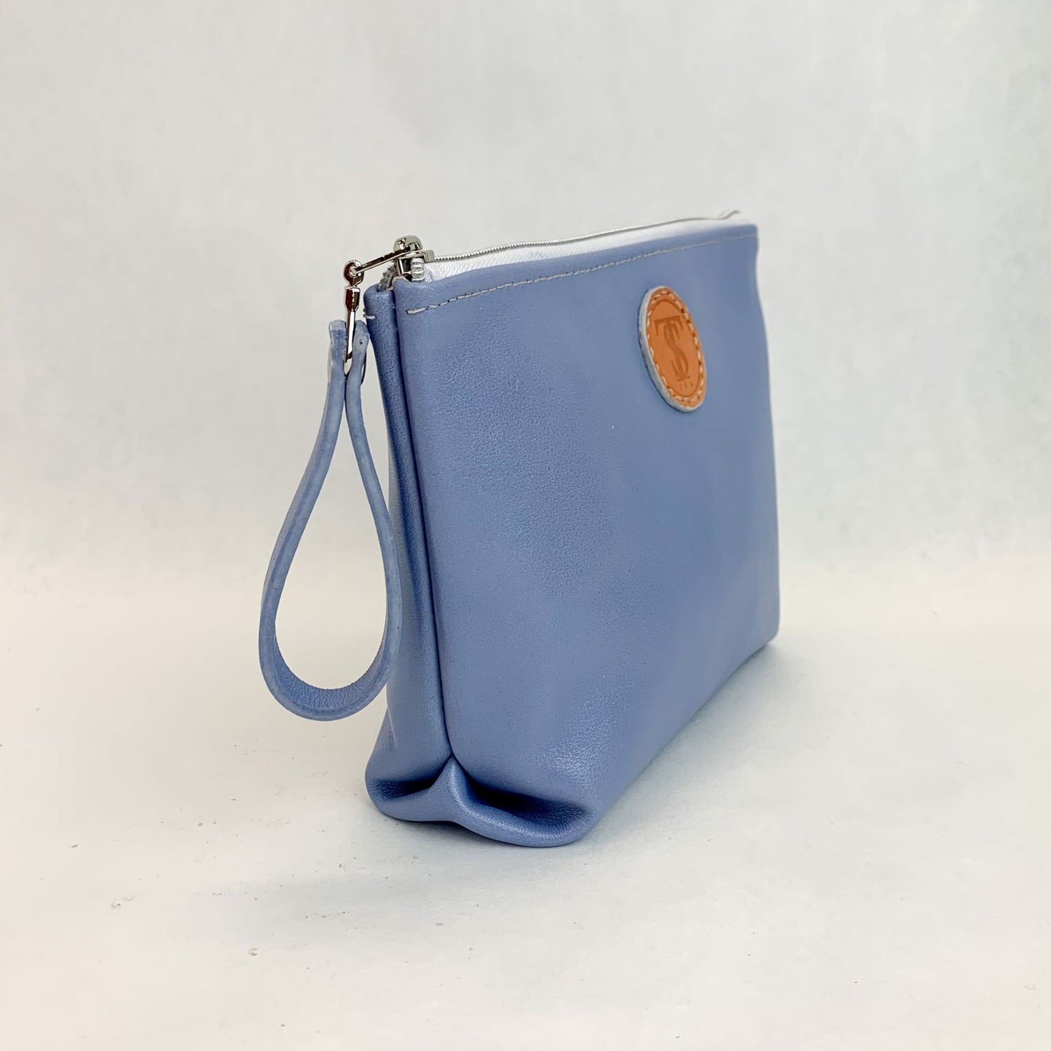 Side view T5 Cosmetics case toiletry bag designer handcrafted in smooth calf leather in light periwinkle blue.