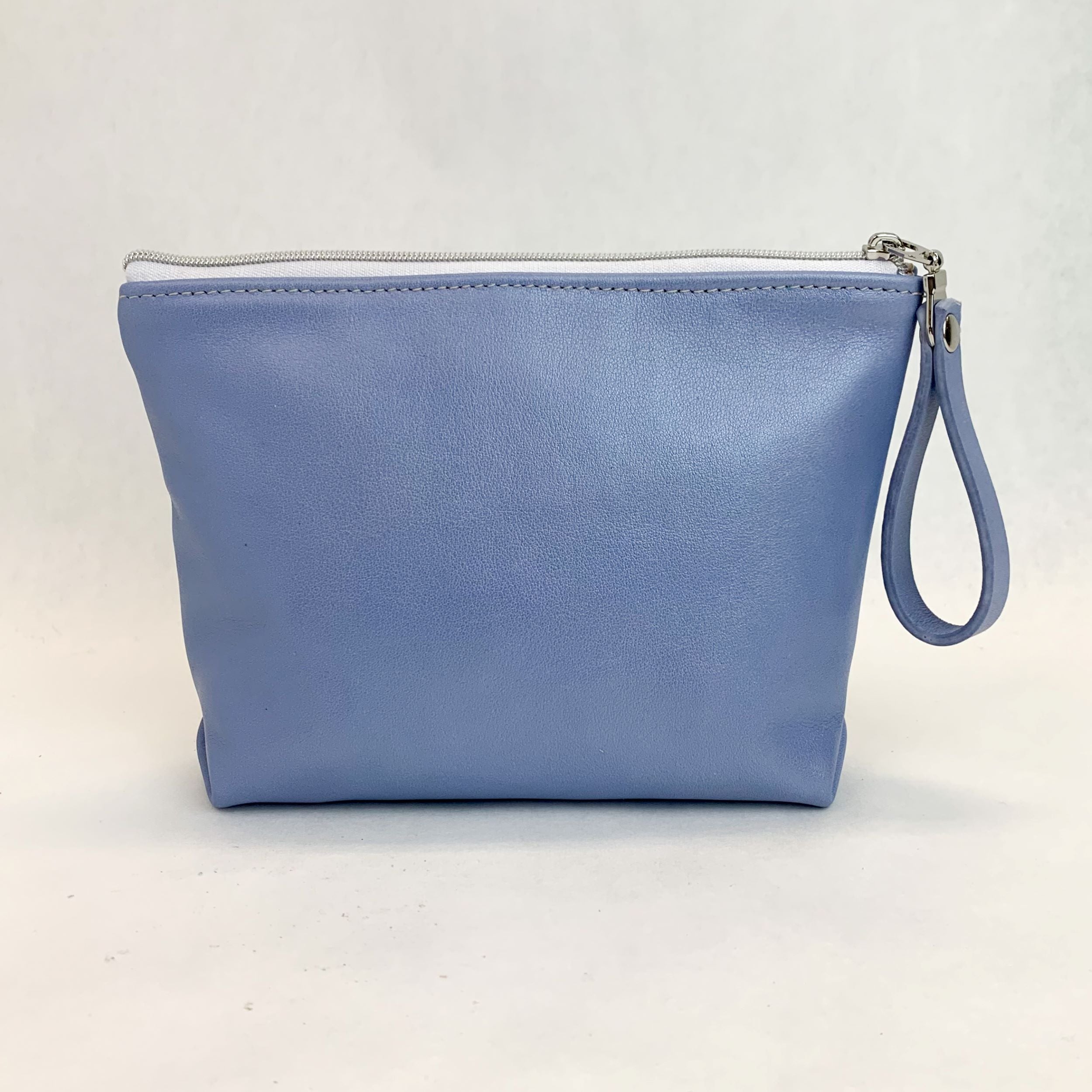 Back view T5 Cosmetics case toiletry bag designer handcrafted in smooth calf leather in light periwinkle blue.
