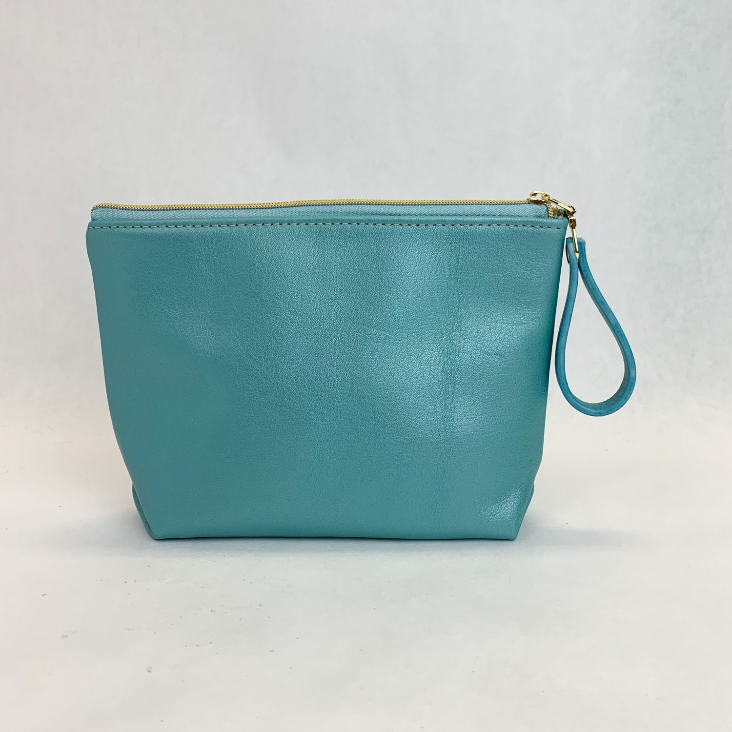 Back view T5 Cosmetics case toiletry bag designer handcrafted in smooth calf leather in turquoise.