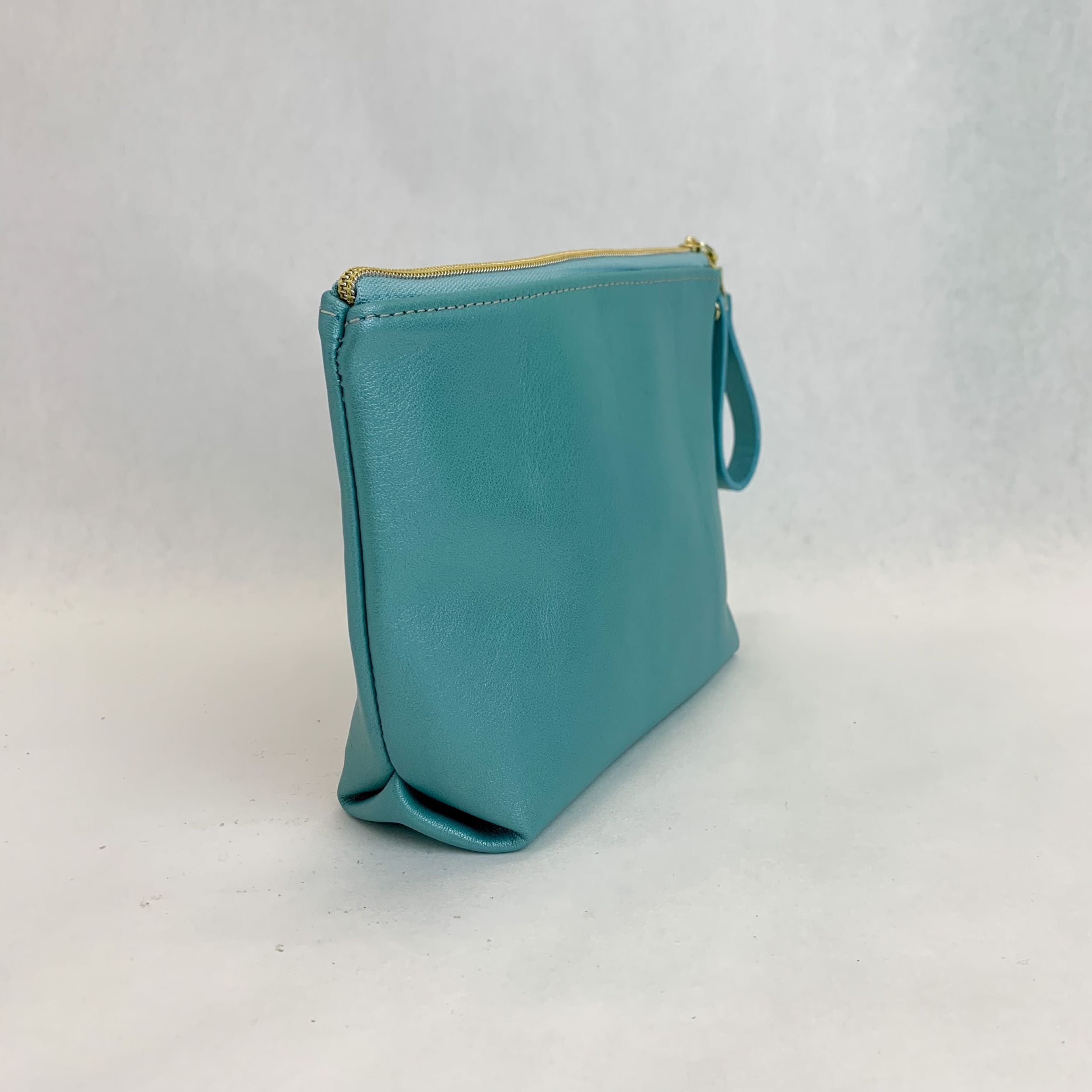 Side view T5 Cosmetics case toiletry bag designer handcrafted in smooth calf leather in turquoise.