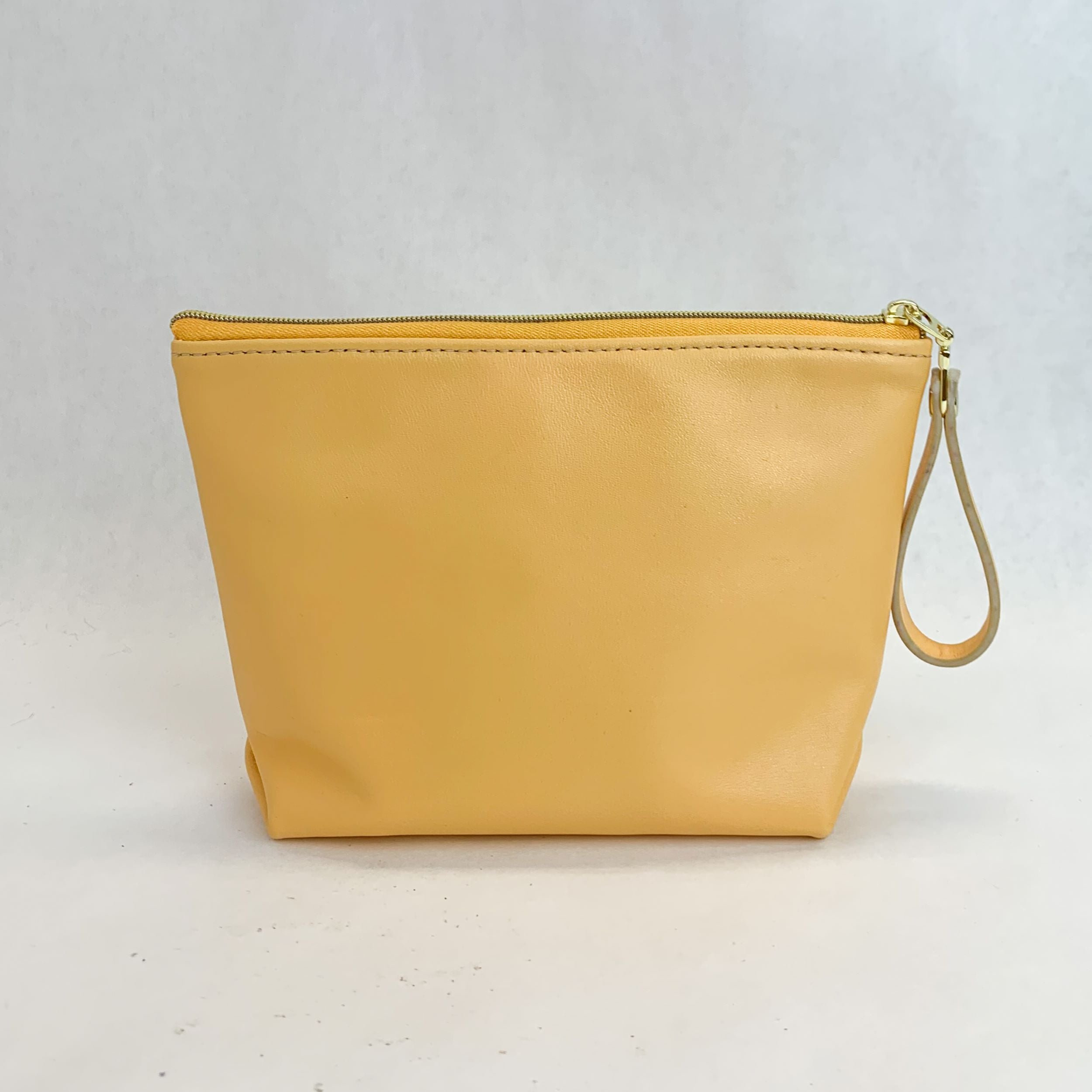 Back view T5 Cosmetics case toiletry bag designer handcrafted in smooth calf leather in saffron yellow.