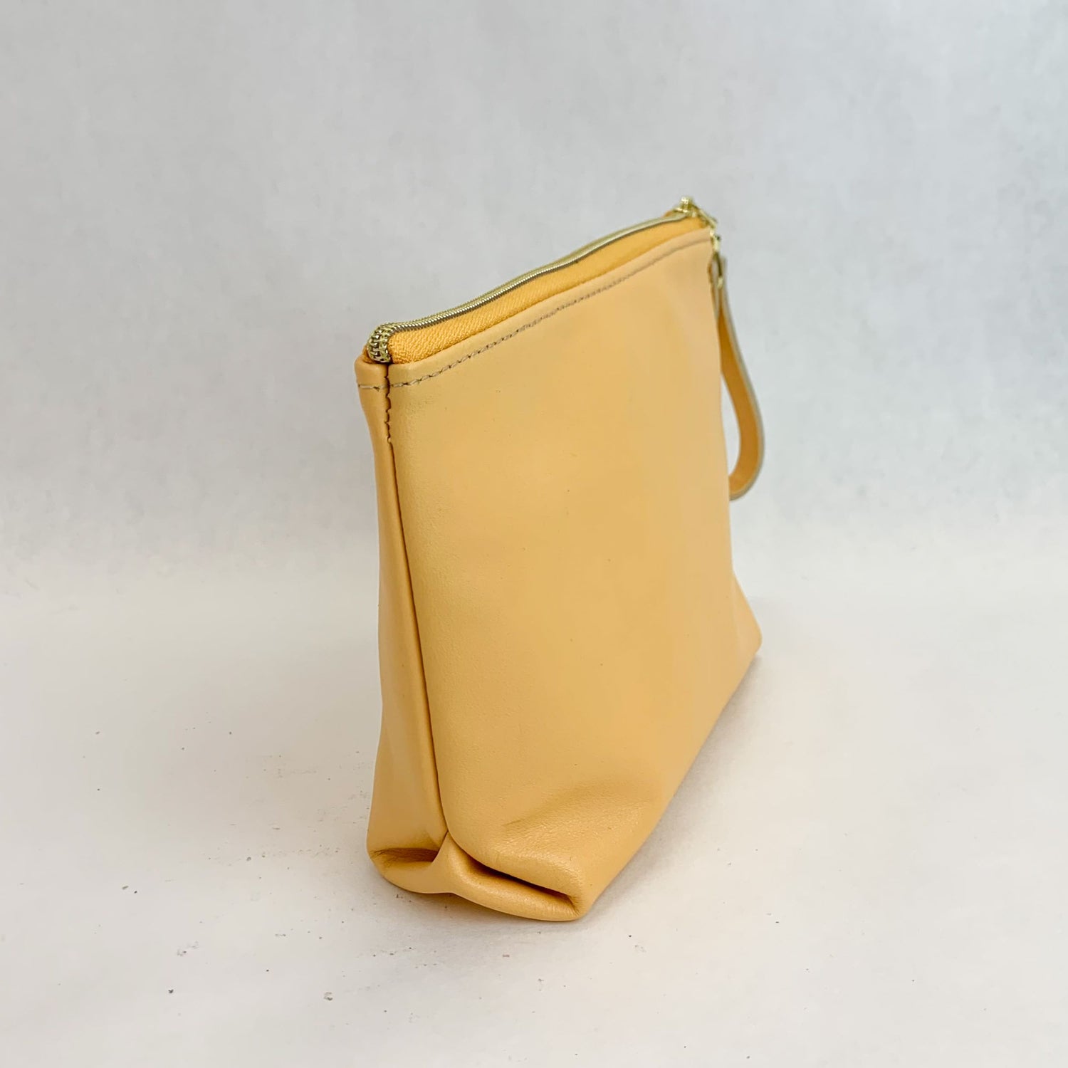 Side view T5 Cosmetics case toiletry bag designer handcrafted in smooth calf leather in saffron yellow.