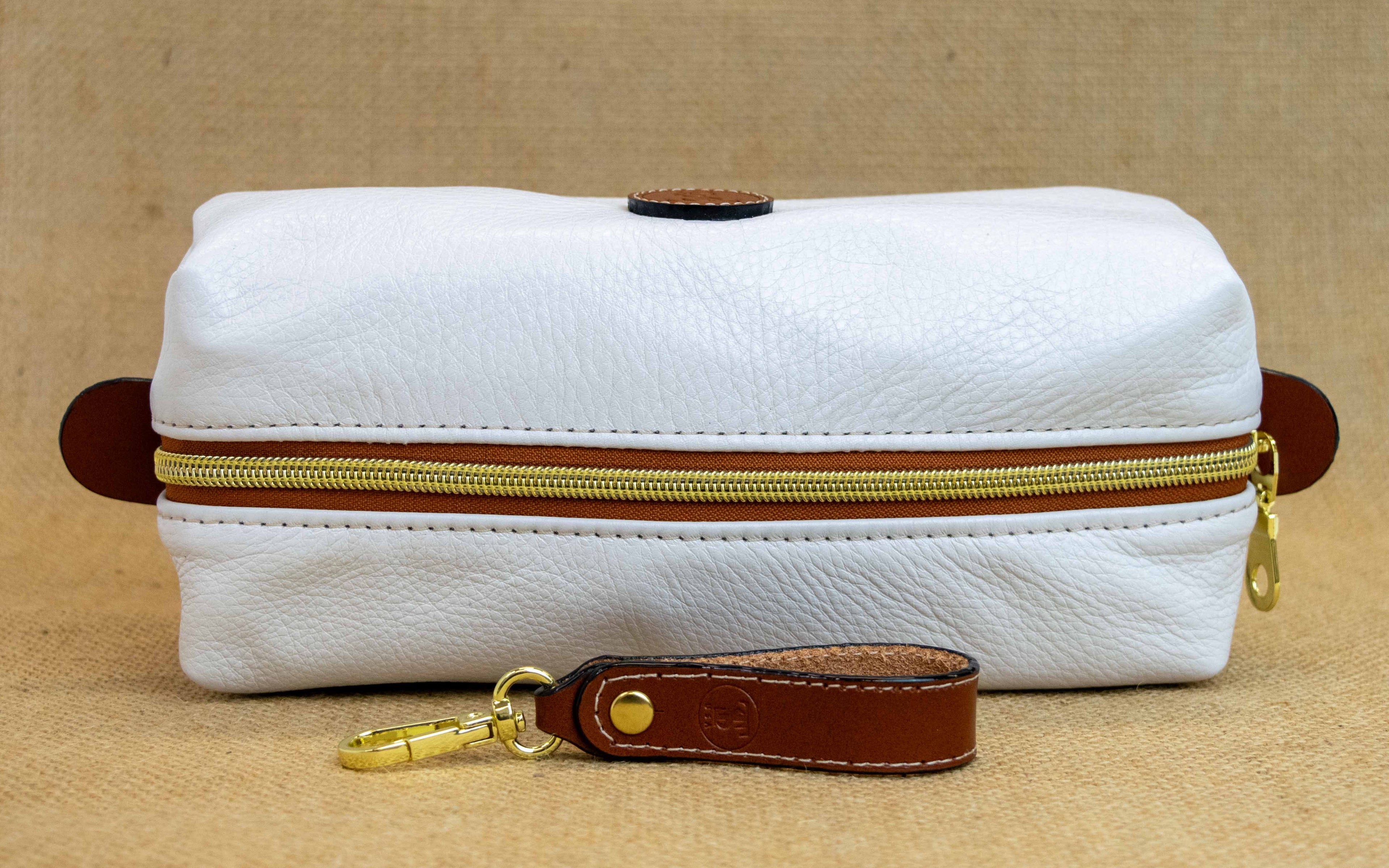 Top view of T5 bath dopp kit toiletry wash bag designer handcrafted of smooth calf leather in yacht white.