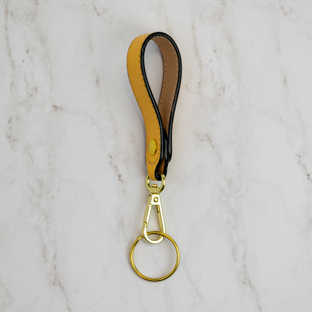 Side view T5 Key chain strap handcrafted by designer Liv McClintock in smooth calf leather in saffron yellow