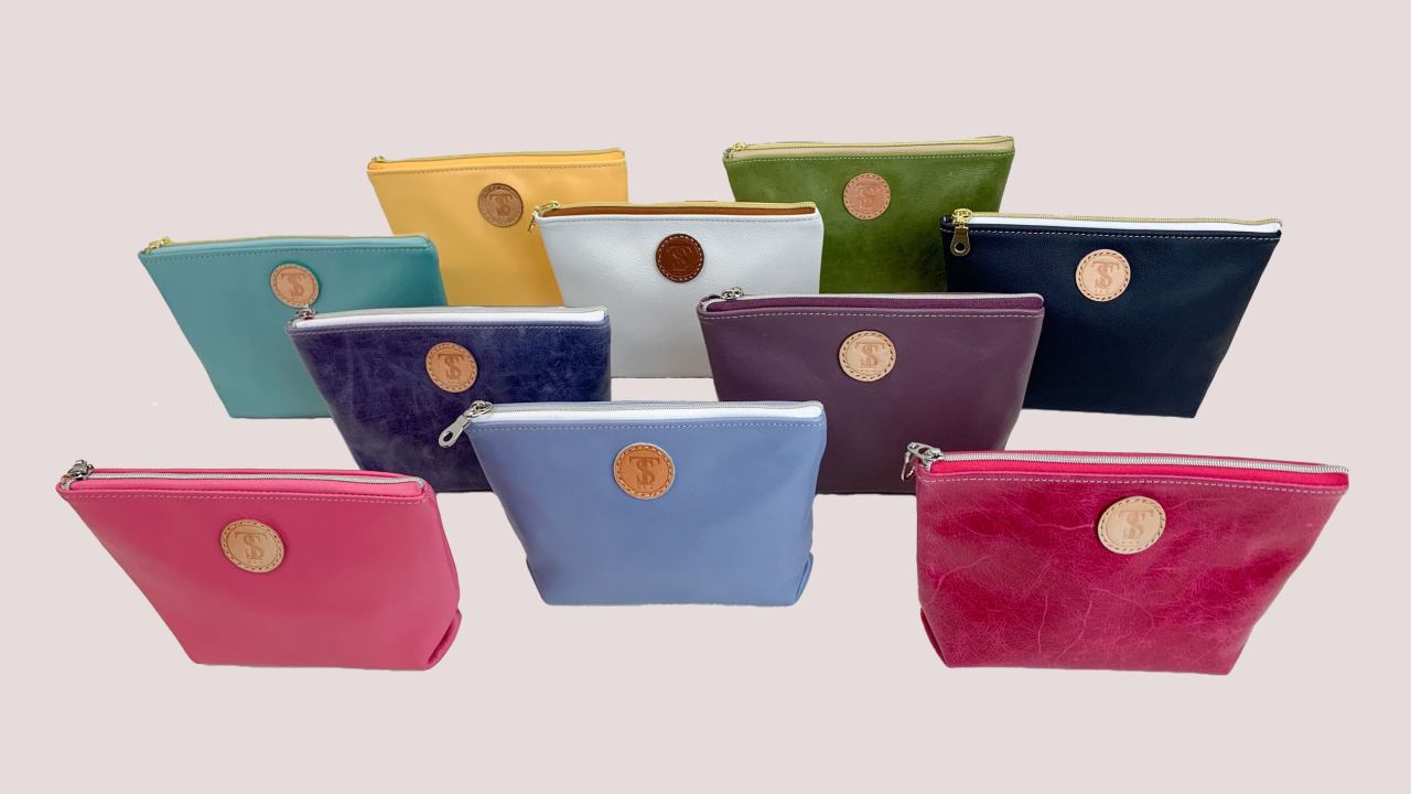 Town & Shore Handcrafted  T5 Calf Leather Cos cases, for cosmetics, travel or toiletries in ten different colors. Colors listed from back to front, Saffron Yellow, Vintage Aloe Green, Frosted turquoise, Yacht white, Nautical Navy, Atlantic Denim blue, Lavender, Frosted pink, Sky blue, Hot Barbie Pink  