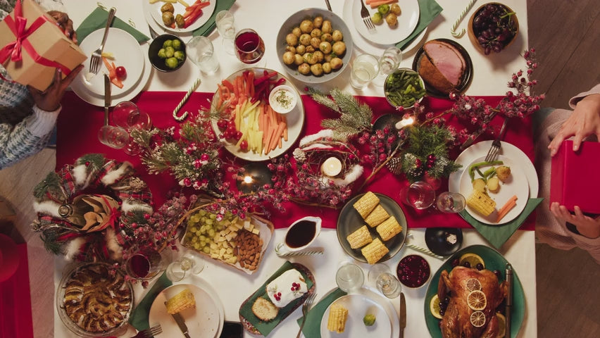 Load video: Festive Chrismas holiday dinner with family passing out gifts to each other.