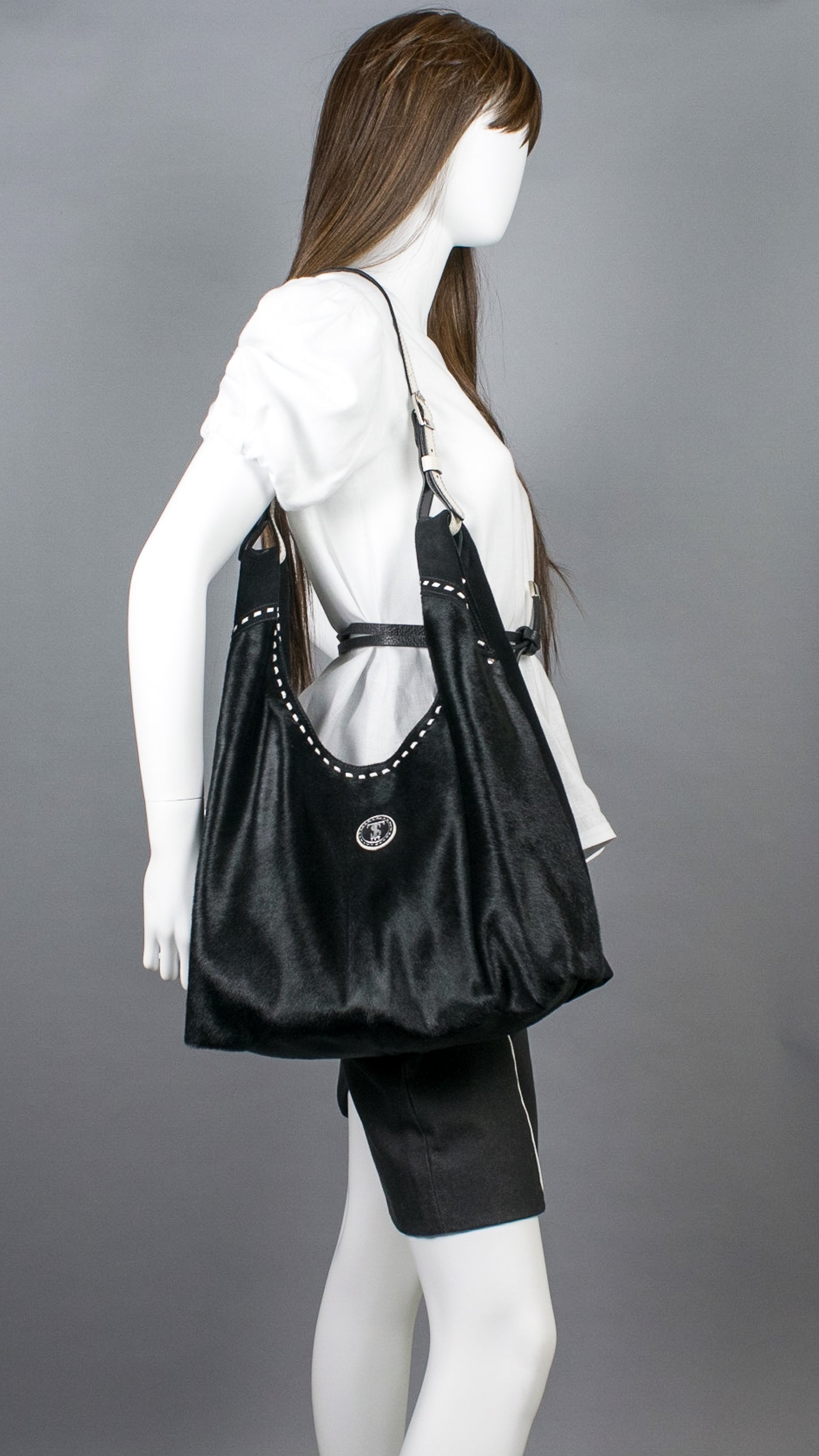 Model in white linen top wearing Leather hobo shoulder bag in jet black hair calf &amp; suede. Handcrafted by slow fashion indie designer Liv McClintock. Features hand laced white leather trim. Made in Wilmington Delaware USA.