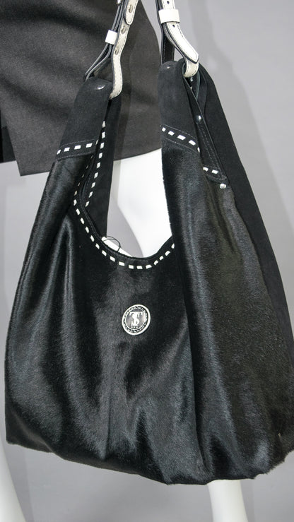 Close up of Leather hobo shoulder bag in jet black hair calf &amp; suede. Handcrafted by slow fashion indie designer Liv McClintock. Features hand laced white leather trim. Made in Wilmington Delaware USA.