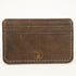 Front view of Distressed finish Chocolate brown leather slim card case with two front pockets center pocket gold brand logos on front 