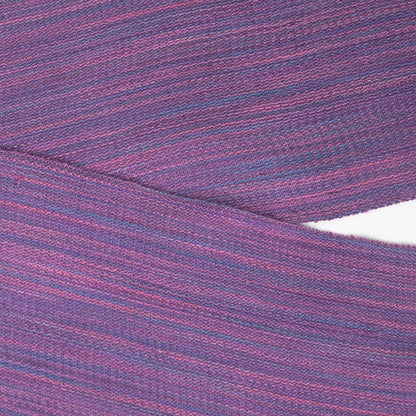 Close up of Handwoven scarf in rich varigated colors of purple, pink and blue with fringe on end